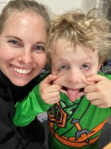 image of a Mum next to a small boy pulling a face